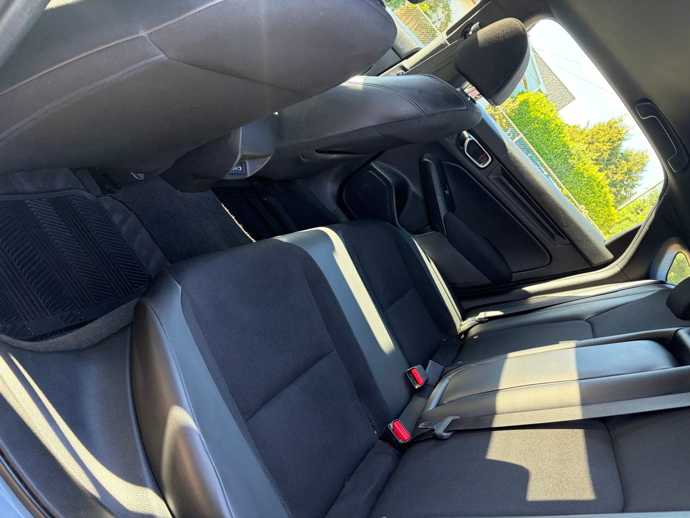 Cleaned black cloth and leather seats after an interior detail